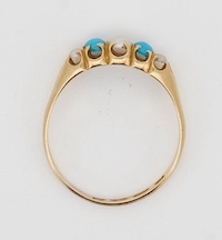 A Victorian 18ct gold, three stone split pearl and two stone turquoise set half hoop ring, size O/P, gross weight 2.5 grams.